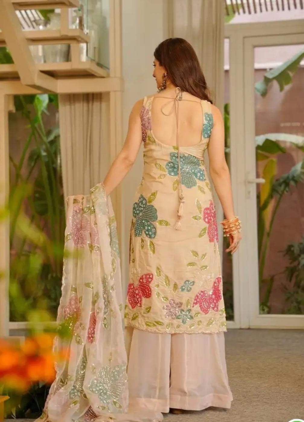 Cream organza silk plazzo suit set is adorned with colorful brush prints with sequence work