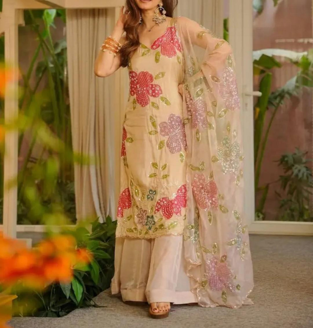 Cream organza silk plazzo suit set is adorned with colorful brush prints with sequence work
